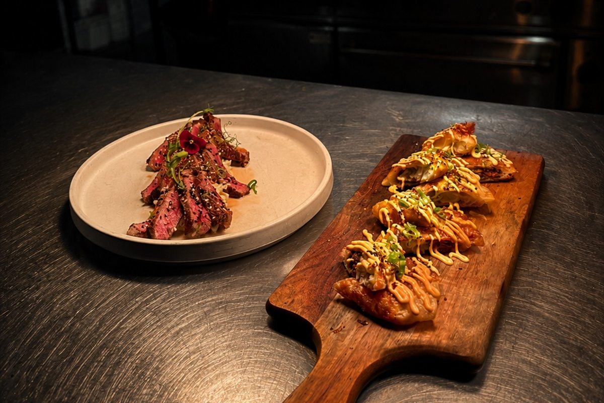 Sliced wagyu and loaded gyoza on the kitchen pass